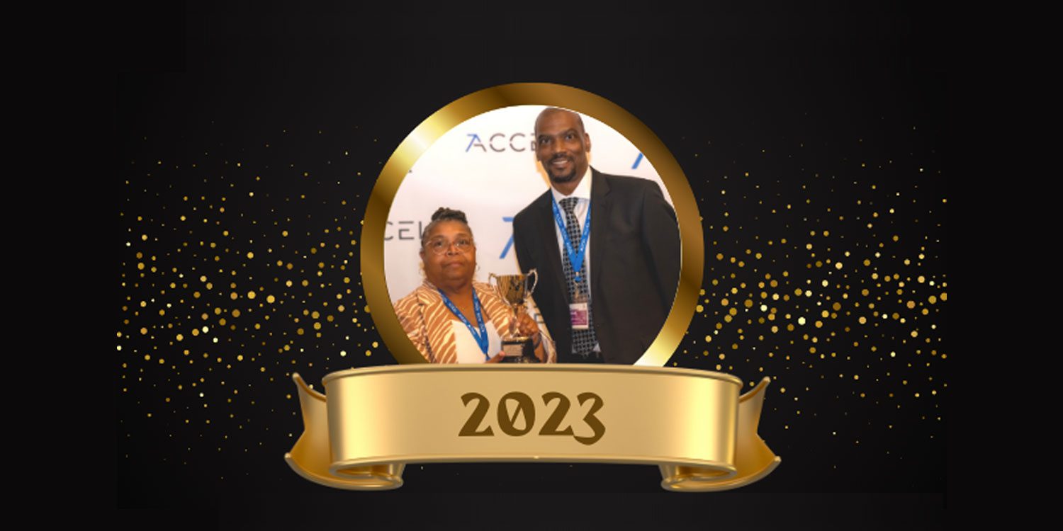 Two adults with a golden trophy in a circular frame.