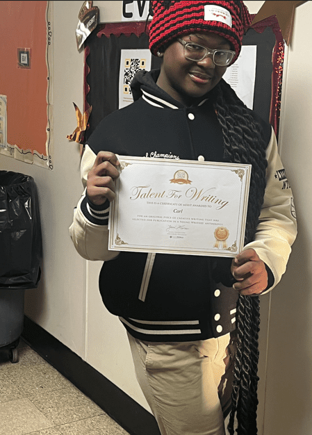 Adult holding a certificate for writing talent.