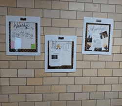Three bulletin boards with papers and decorations on a brick wall.