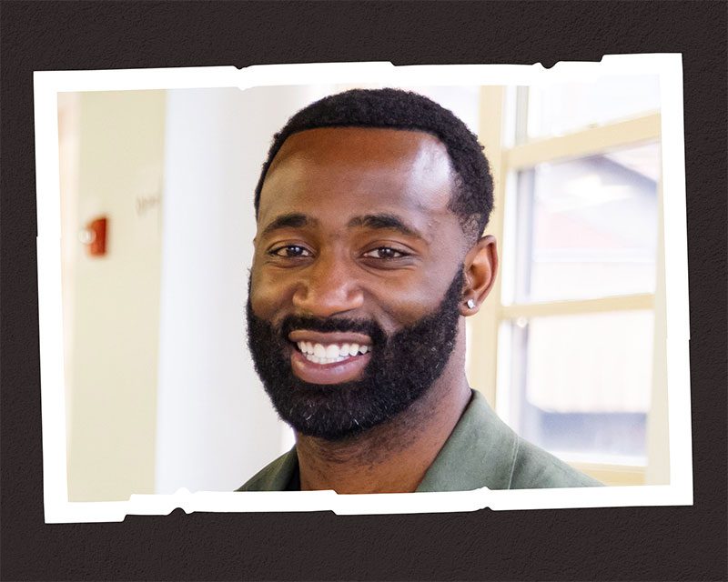 Smiling adult with beard and short hair.