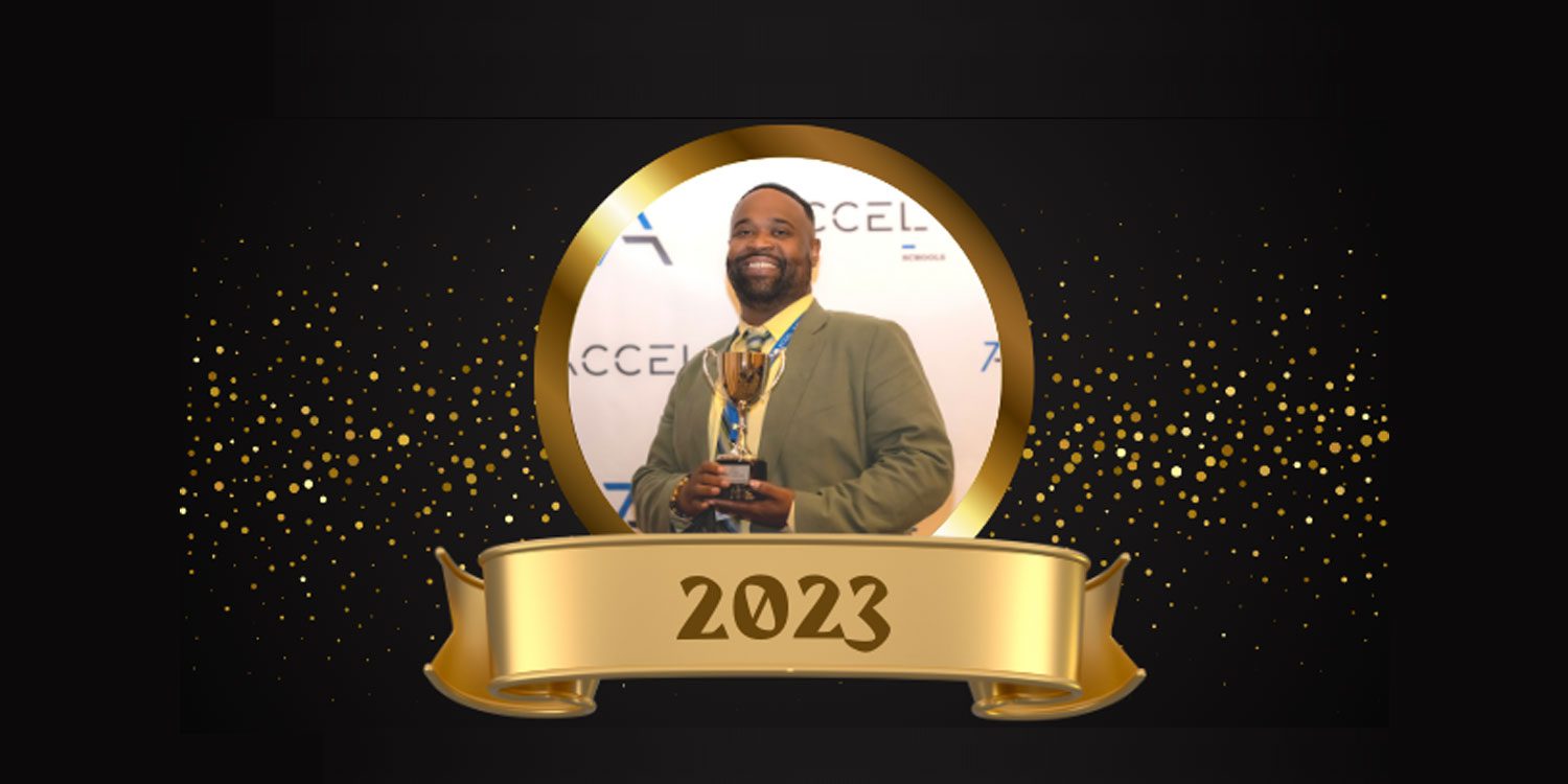 Smiling adult holding a trophy in a gold circular frame.