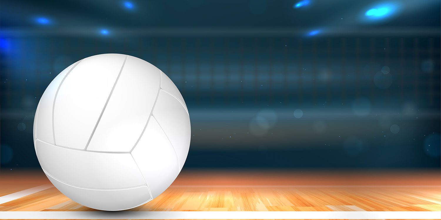 Volleyball on a wooden court with blue lights in the background.
