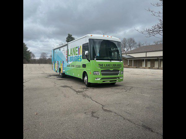 Bookmobile parked in an empty lot.
