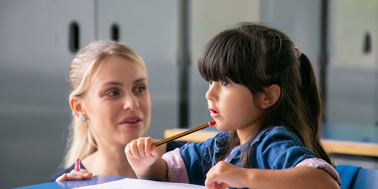 Adult and child interacting during a learning activity.