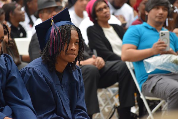 Child in blue graduation cap and gown.