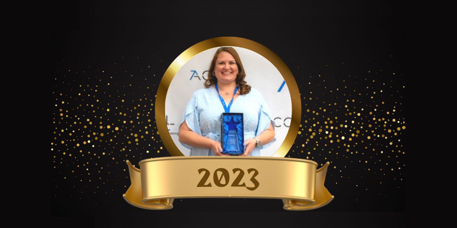 Adult holding a star-shaped award with the year 2023.