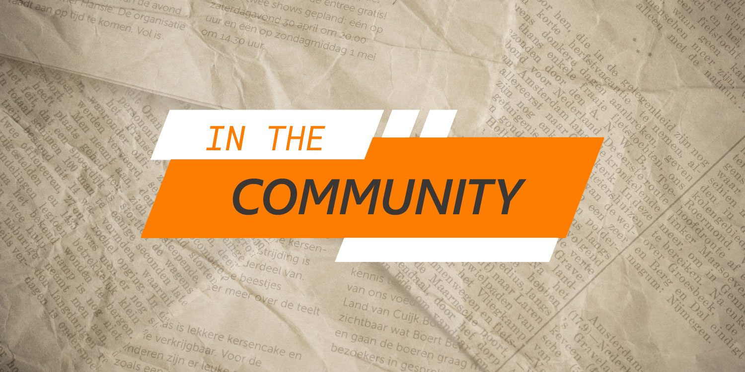 Orange and white text "IN THE COMMUNITY" on newspaper.