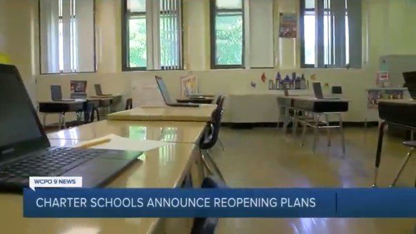 Empty classroom with laptops on desks, ready for students.