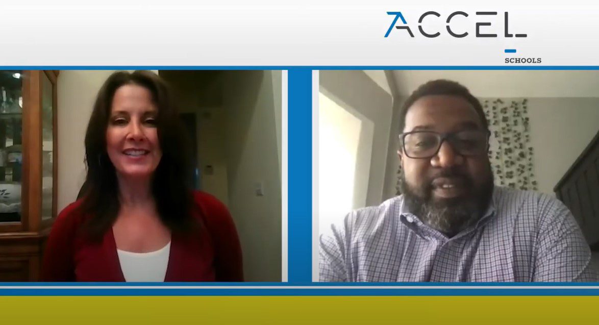 Two adults smiling during a video call with a company logo.