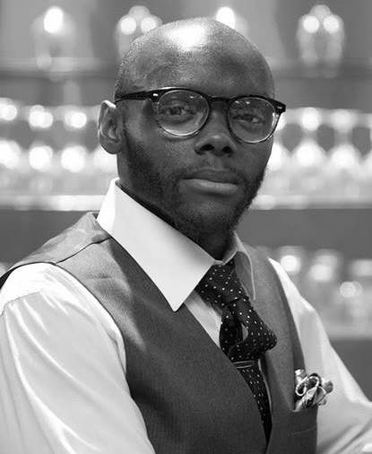 Adult in glasses and formal wear.