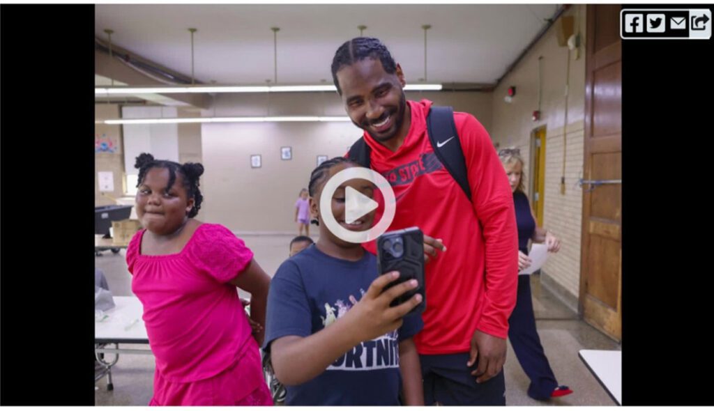 Adult and two children smiling while taking a selfie.
