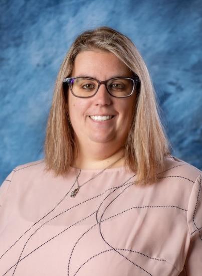 Adult with glasses smiling.